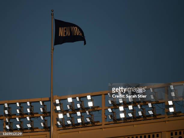Flag reading "New York" flies during the first inning between the Boston Red Sox and the New York Yankees at Yankee Stadium on August 14, 2020 in the...