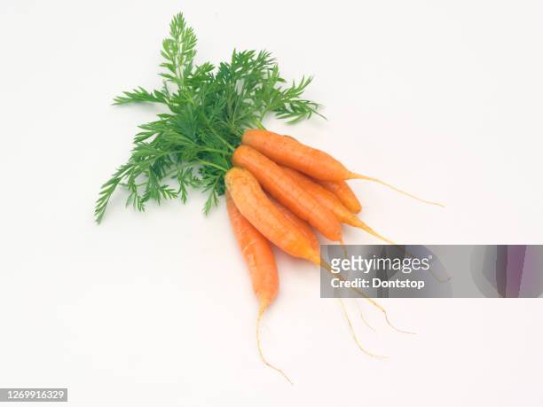 organic fresh carrots on wooden background. - carrot isolated stock pictures, royalty-free photos & images