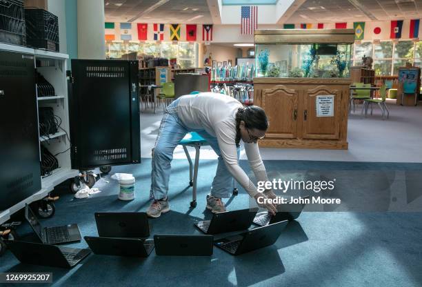 Elaine Jencarelli, technical integration support specialist, cleans Chromebooks while preparing for the Sept. 8 start of school at Newfield...