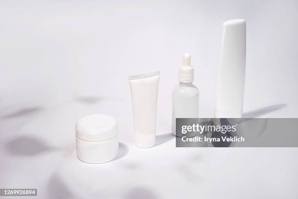 luxury white cosmetic products on white background. - shampoo bottle white background stock pictures, royalty-free photos & images