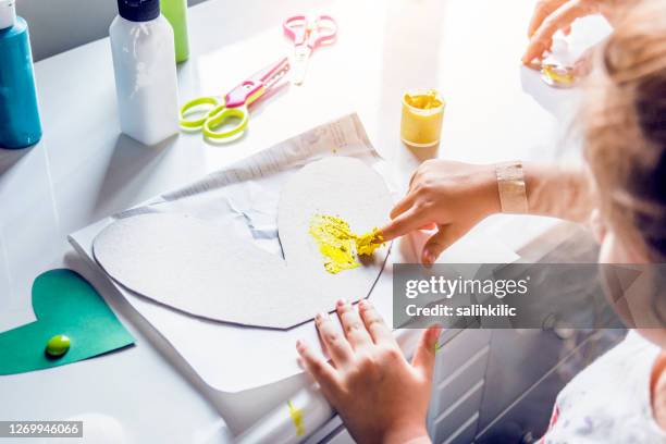 little girl doing finger painting - kids arts and crafts stock pictures, royalty-free photos & images