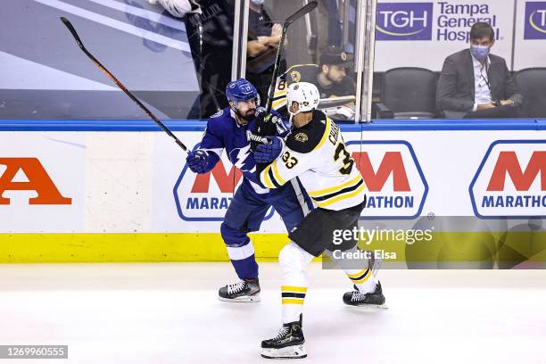Alex Killorn of the Tampa Bay Lightning and Zdeno Chara of the Boston Bruins battle along the boards during the first period in Game Five of the...