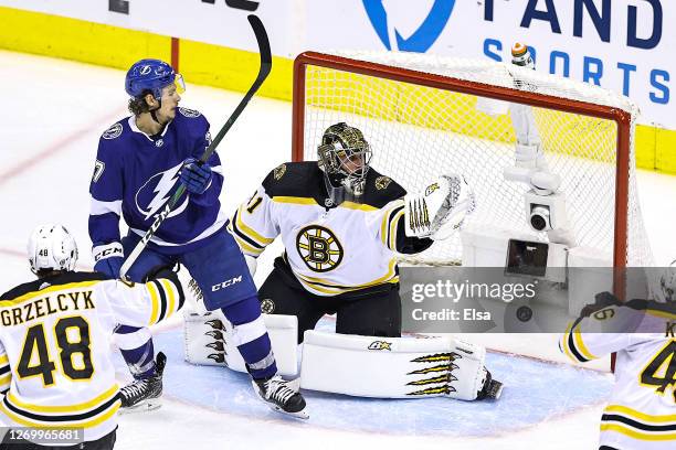 Jaroslav Halak of the Boston Bruins allows a goal to Ondrej Palat of the Tampa Bay Lightning as Yanni Gourde looks on during the second period in...