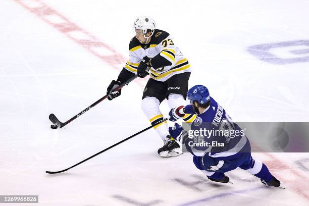 Charlie McAvoy of the Boston Bruins is defended by Nikita Kucherov of the Tampa Bay Lightning during the second period in Game Five of the Eastern...