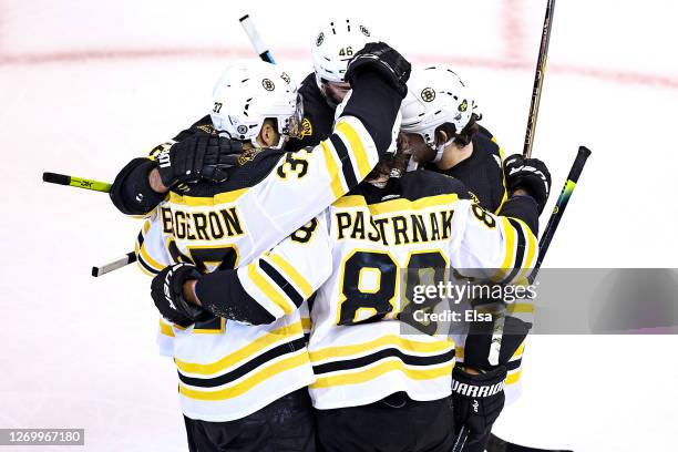 David Pastrnak of the Boston Bruins is congratulated by his teammates after scoring a goal against the Tampa Bay Lightning during the second period...