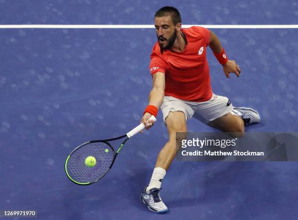 Damir Dzumhur of Bosnia and Herzegovina returns a volley during his Men's Singles first round match against Novak Djokovic of Serbia on Day One of...