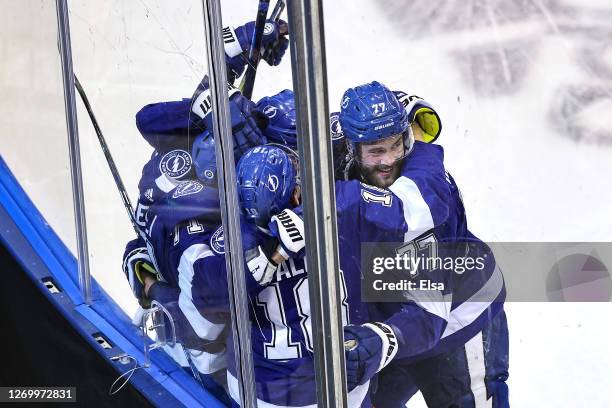 Anthony Cirelli of the Tampa Bay Lightning is congratulated by his teammates after scoring a goal against the Boston Bruins during the third period...