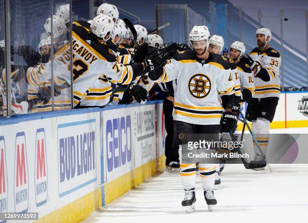 David Krejci of the Boston Bruins celebrates with teammates on the bench after scoring to tie the game at 2-2 late in the third period of Game Five...