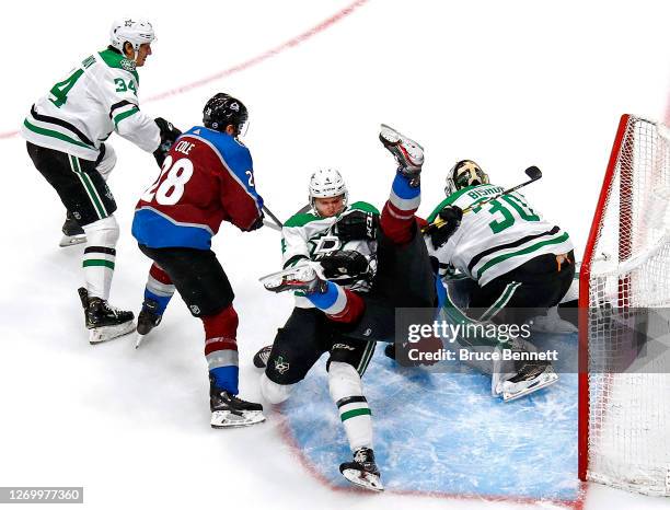 Miro Heiskanen of the Dallas Stars checks Andre Burakovsky of the Colorado Avalanche during the first period in Game Five of the Western Conference...
