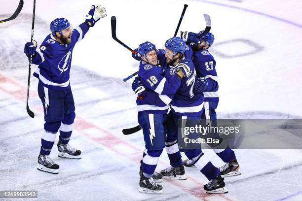 Victor Hedman of the Tampa Bay Lightning is congratulated by his teammates, Ondrej Palat, Alex Killorn, and Barclay Goodrow after scoring the...