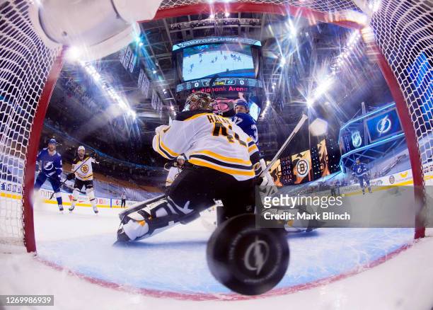 Goaltender Jaroslav Halak of the Boston Bruins can't make the save on a deflection for a goal by Ondrej Palat of the Tampa Bay Lightning in the...