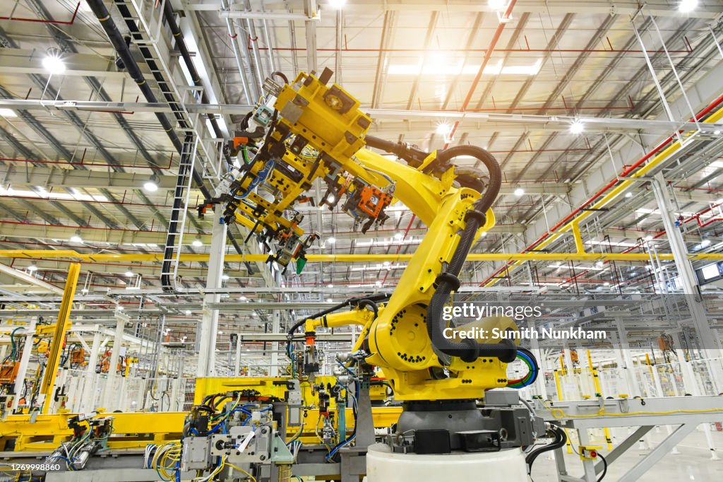 Automobile plant, Industrial machinery automatic arm welding cars robot in production line of vehicle manufacturer factory