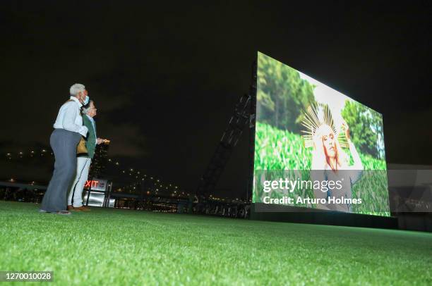 Bethann Hardison and Mark Bozek watched the beginning of the private outdoor screening of "The Times of Bill Cunningham" at Pier 17 on August 31,...