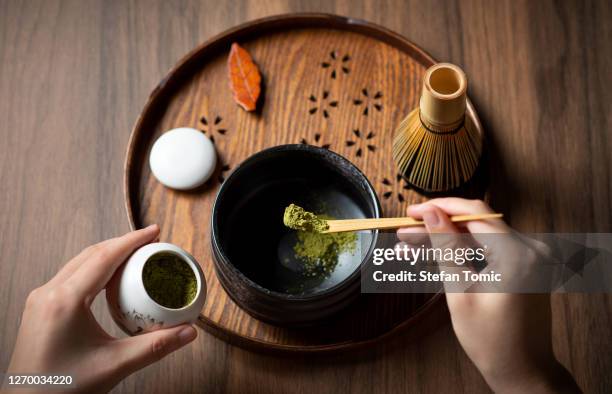 woman making matcha green tea with traditional accessories for tea ceremony - powder tea stock pictures, royalty-free photos & images