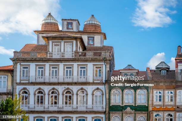 traditional facades and striking roofs in guimaraes, portugal - braga city stockfoto's en -beelden