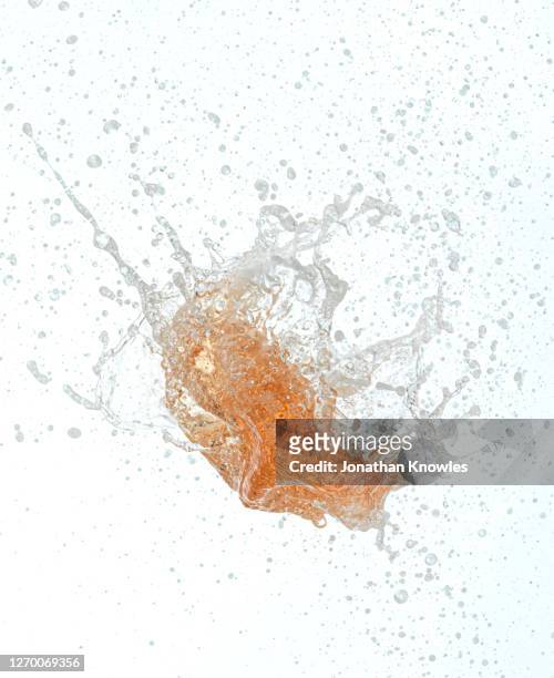 exploding orange liquid - bubble burst stock pictures, royalty-free photos & images