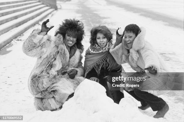 American vocal group the Three Degrees pose in the snow near the Royal Albert Hall in London, UK, 18th January 1985. From left to right, they are...