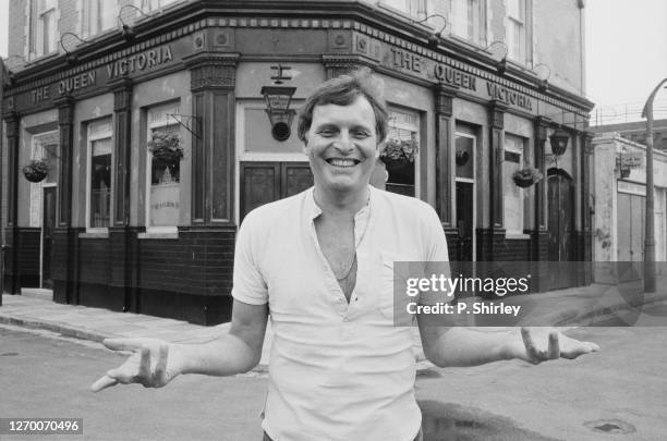 British actor Peter Dean outside the Queen Victoria pub on the set of the BBC soap opera 'Eastenders', UK, 17th June 1985. He is known for playing...