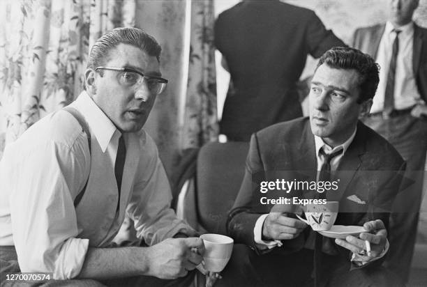 Twin brothers Ronald and Reginald Kray at home after 36 hours of police questioning concerning the murder of George Cornell, UK, 1966. Cornell, a...