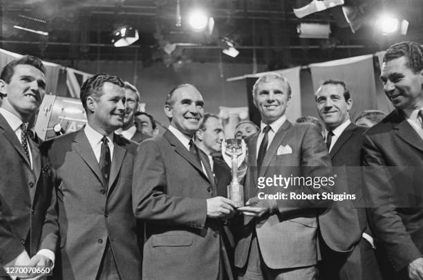 The England World Cup team holding the Jules Rimet trophy as they celebrate their win in the final, 31st July 1966. From left to right, Terry Paine,...