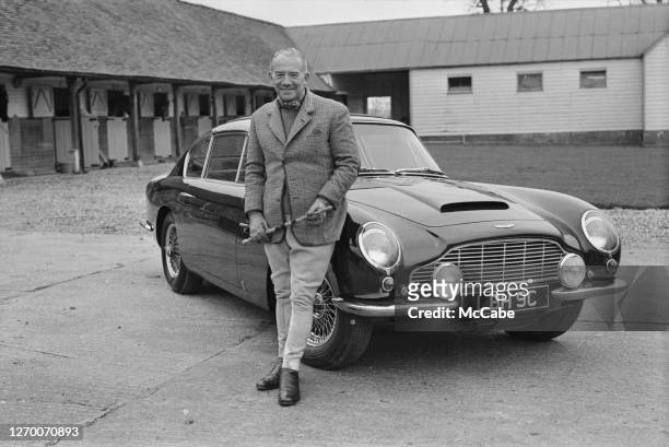 English entrepreneur David Brown , owner of the car manufacturing firm Aston Martin Lagonda, 1966. He is posing with an Aston Martin DB6 with...