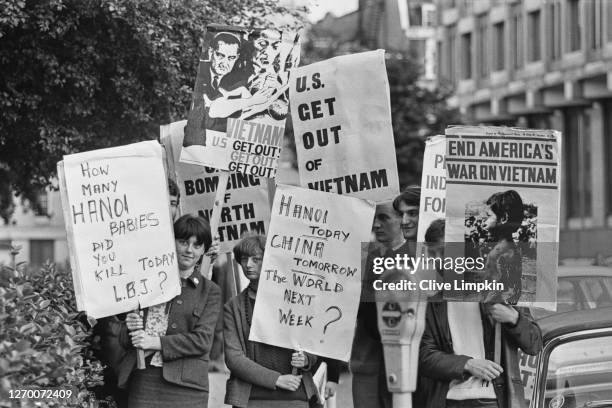 An anti-Vietnam War demonstration outside the US Embassy on Grosvenor Square, London, 29th June 1966. One young woman asks of US President Lyndon B...