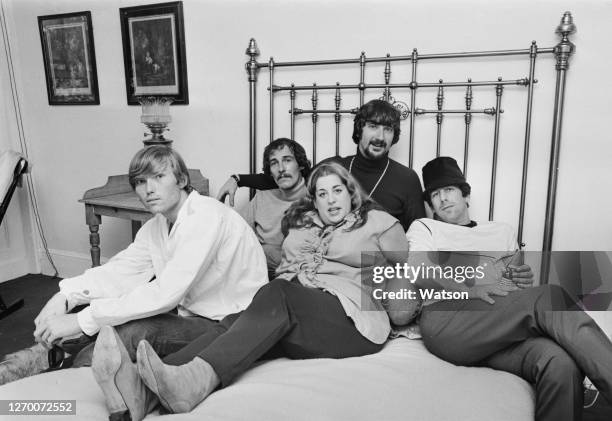 American folk rock group The Mamas and the Papas, 15th June 1966. From left to right, they are record producer Terry Melcher, band members John...