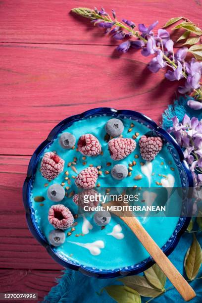 colazione con ciotola di yogurt alla spirulina blu con bacche sul tavolo rosa - blue bowl foto e immagini stock