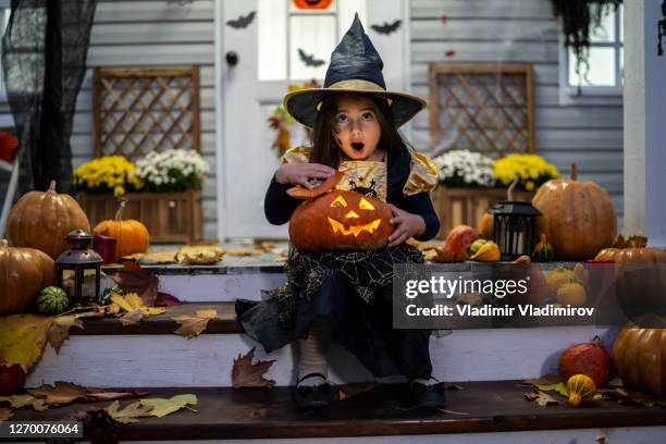 a small girl with a pumpkin lantern - happy halloween stock pictures, royalty-free photos & images