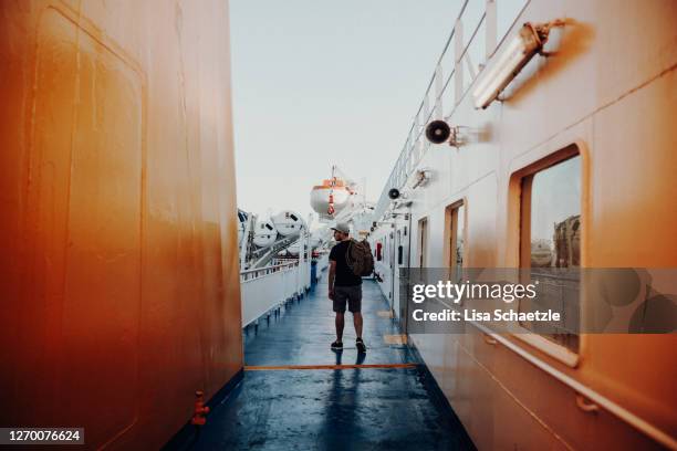 portrait of a man standing on a ferry deck looking out to sea - ferry stock pictures, royalty-free photos & images