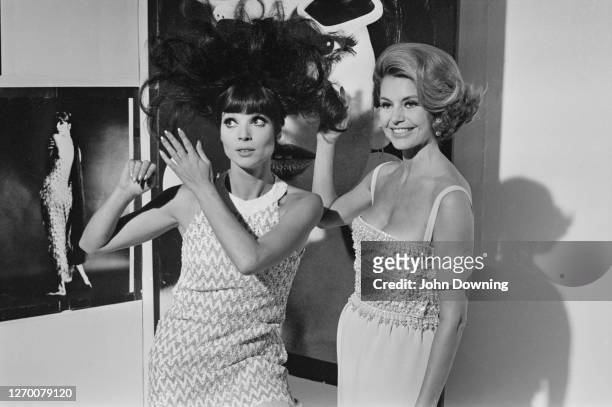 Actresses Elsa Martinelli and Cyd Charisse in an art gallery in Chelsea, London, during the filming of 'Maroc 7', 27th August 1966.