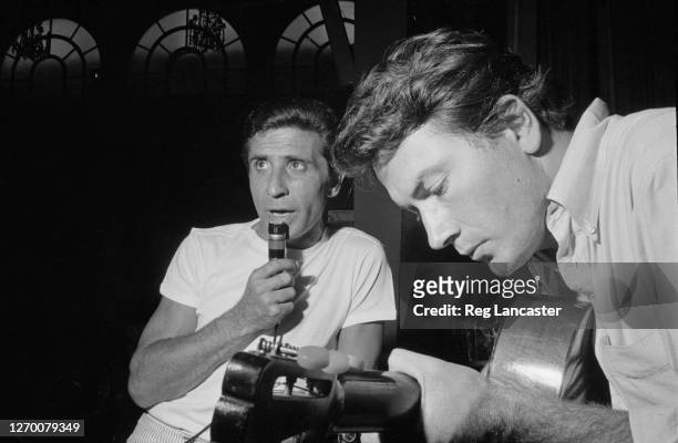 French singer Gilbert Bécaud rehearsing with a guitarist at his home, 17th August 1966. He is preparing for a concert at the Royal Festival Hall in...