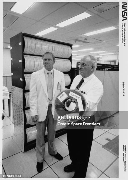 Stan Williams of Lockheed and Luther D Palmer of NASA with a copy of the tape from the Modular Auxiliary Data System recorder of Space Shuttle...