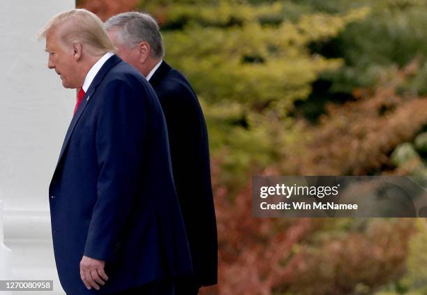 President Donald Trump confers with White House Chief of Staff Mark Meadows while departing the White House September 1, 2020 in Washington, DC....