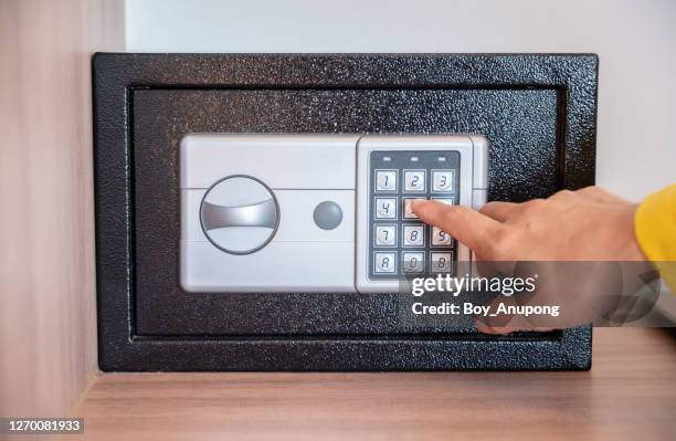 someone hand trying to press passwords on safety lock pad for open a safety box. - password strength stock pictures, royalty-free photos & images