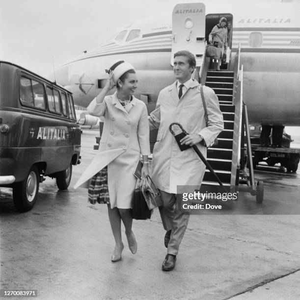 British actor and producer David Niven Jr, the son of actor David Niven, arrives at London Airport with Italian actress Rosanna Schiaffino , 21st...