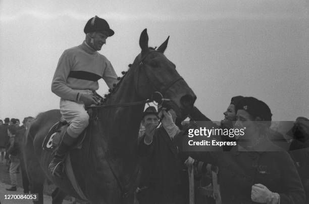Anne Grosvenor, Duchess of Westminster congratulates Irish jockey Pat Taaffe on her racehorse Arkle, after they won the Gold Cup at Cheltenham Races,...