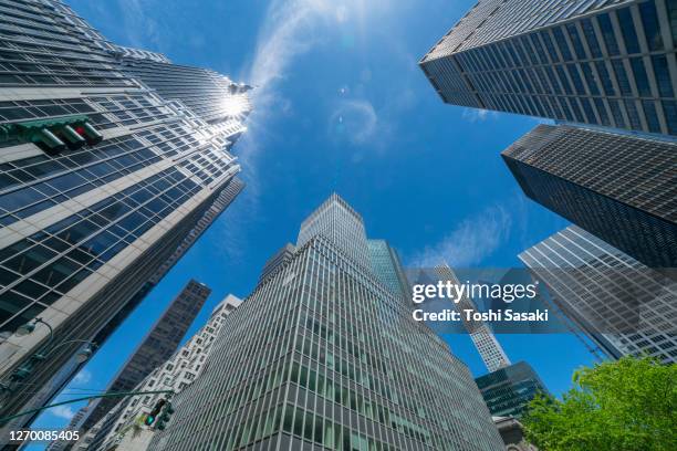 rows of midtown manhattan high-rise buildings stand along the park avenue - midtown manhattan ストックフォトと画像