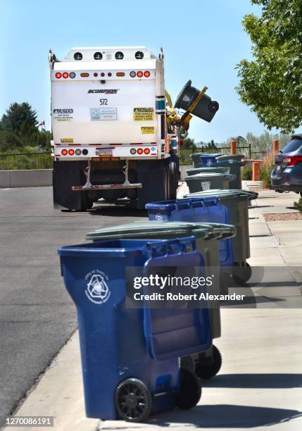 Scorpion garbage truck made by Dadee Manufacturing picks up residential refuse in Santa Fe, New Mexico.