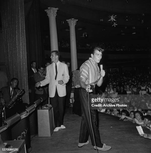 American actor and singer Fabian performing on stage, circa 1960. His audience is mainly female.