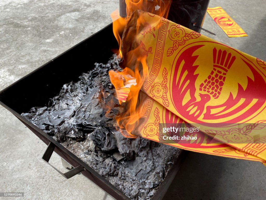 Chinese Lunar Ghost Festival burns money for ancestors.