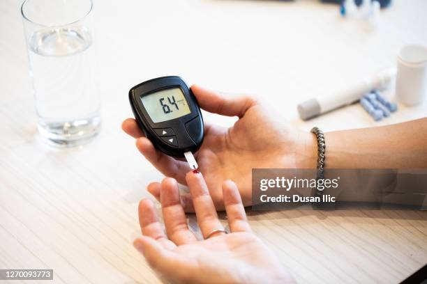 measuring blood sugar level - glycemia stock pictures, royalty-free photos & images