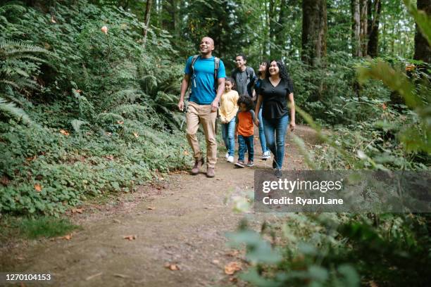 family enjoying hike on forest trail in pacific northwest - family hiking stock pictures, royalty-free photos & images