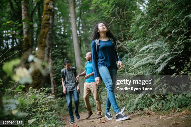 family enjoying hike on forest trail in pacific northwest - washington state trees stock pictures, royalty-free photos & images