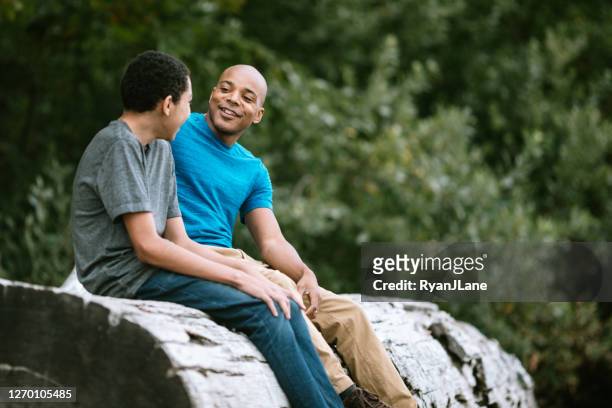 father and teenage son have heart to heart talk - parent stock pictures, royalty-free photos & images