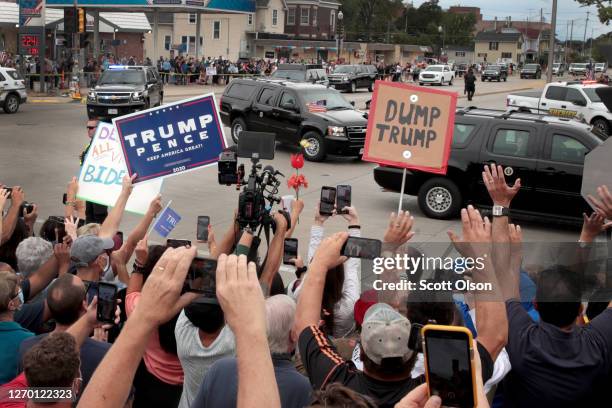 Trump supporters and Trump protesters watch as the motorcade carrying President Donald Trump passes by on September 1, 2020 in Kenosha, Wisconsin....