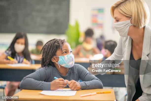 6 year old, african american student wearing a protective face mask in class - teacher stock pictures, royalty-free photos & images