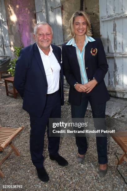 President of the "Olympique Lyonnais" Football Club Jean-Michel Aulas and journalist Anne-Laure Bonnet attend the 13th Angouleme French-Speaking Film...