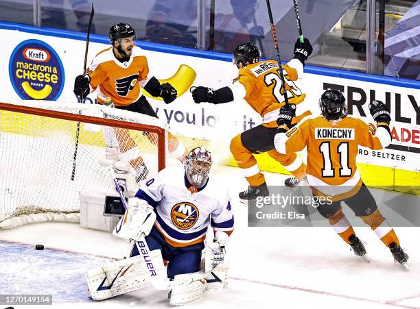 Semyon Varlamov of the New York Islanders is congratulated by his teammates after scoring a goal past Semyon Varlamov of the New York Islanders...