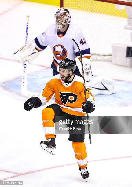 Scott Laughton of the Philadelphia Flyers celebrates after scoring the game-winning goal past Semyon Varlamov of the New York Islanders during the...